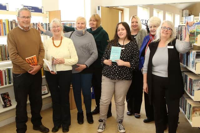 Volunteer librarian Dawn Raffle shows County Council Chairman John Handley around Jacksdale's new community library