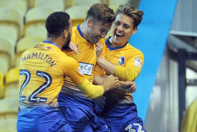 Mansfield Town v Lincoln CityJoel Byrom celebrates his second half goal with CJ Hamilton and Danny Rose.