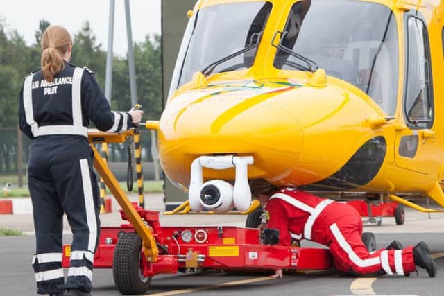 Female crew members work on the iconic ambucopter..