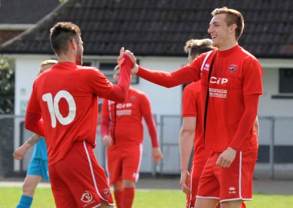 Two more goals for AFC Mansfields talismanic striker Ollie Fearon (right).