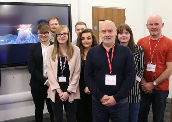 Interactive and creative digital media students pictured with Colin Hall (third right) and brother David (right).