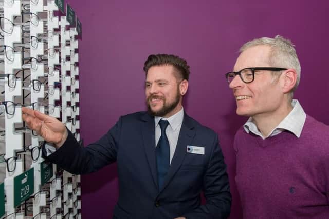 Former Olympic cyclist Bryan Steel (right) checks out the glasses at Vision Express with store manager James South.