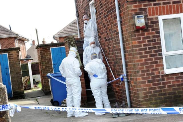 Forensic officers at the property