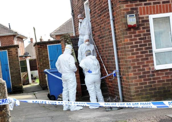 Forensic officers at the property