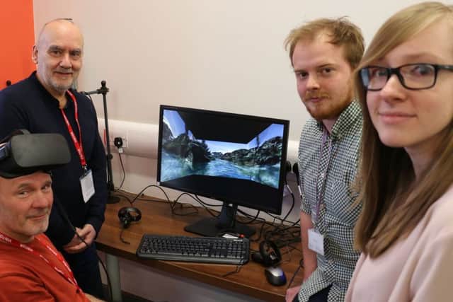 Brothers and scheme developers Colin (left, standing) and David Hall (left, seated) view the virtual reality film, joined by students Luke Buxton and Natasha Finney.