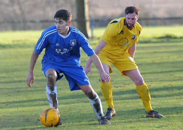 Khyle Sargent (blue), who scored the only goal of the game for Teversal in their win over Holbrook Sports.
