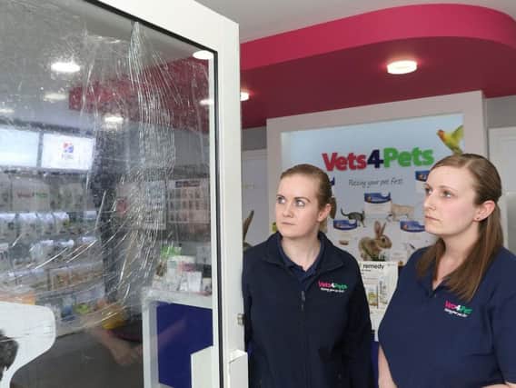 Partners Claire Matan and Stephanie Smith survey the damage after the latest of three attempted break ins at their vet surgery