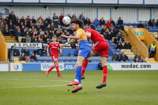 Mansfield Town's Lee Angol in aerial action