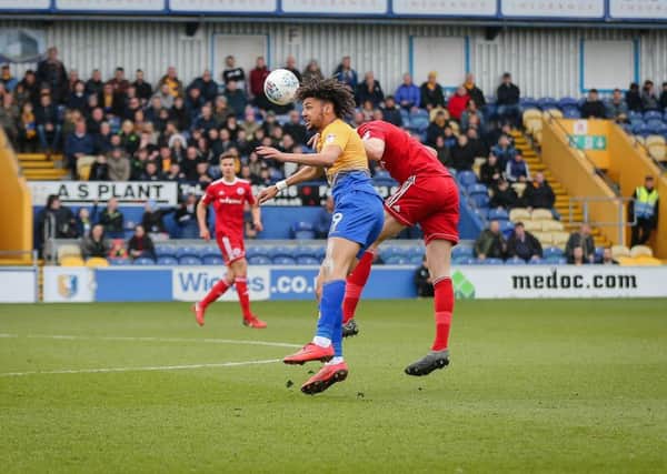 Mansfield Town's Lee Angol in aerial action