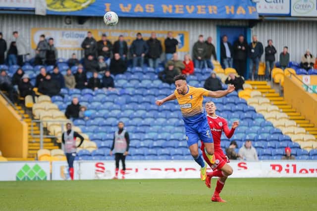 Mansfield Town's Rhys Bennett heads foward