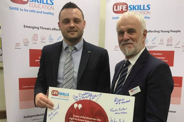 Ben Bradley and Mansfield businessman Andre Camilleri, a trustee of the charity, with the pledge signed by MPs.