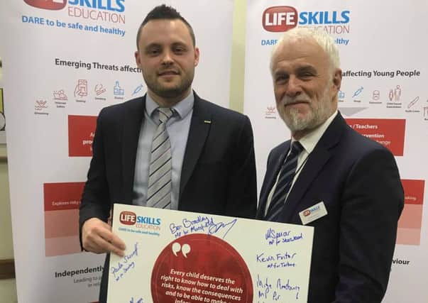 Ben Bradley and Mansfield businessman Andre Camilleri, a trustee of the charity, with the pledge signed by MPs.