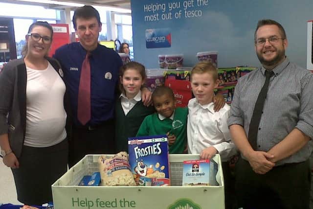 Head teacher Mark Thrower and pupils donating items to a food bank, showing the good work Oak Tree Primary School does in the community.