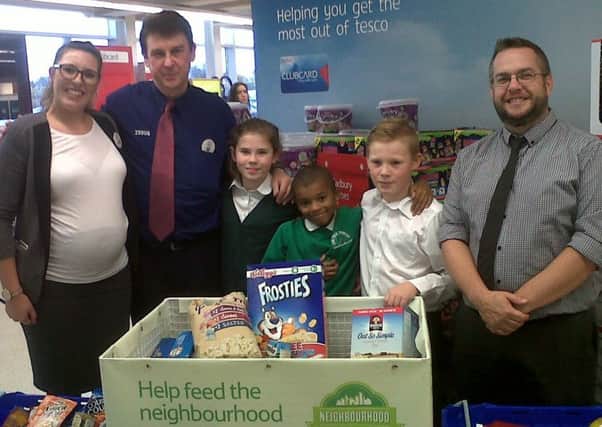 Head teacher Mark Thrower and pupils donating items to a food bank, showing the good work Oak Tree Primary School does in the community.