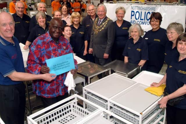 The former President of Zambia, Dr Kenneth Kaunda visited The Nottinghamshire Police Aid Convoy warehouse in Forest Town on Wednesday to thank the team for their continued support. Dr Kaunda, front is pictured with David Scott, left, Chairman of the Notts Police Aid Convoy watched by Mansfield Mayor Tony Egginton, centre and aid volunteers in 2009.
