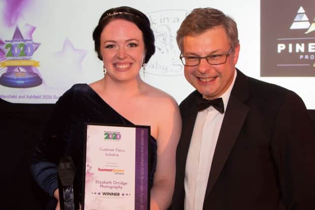 Photographer Elizabeth Orridge receives her Customer Focus Initiative award.
