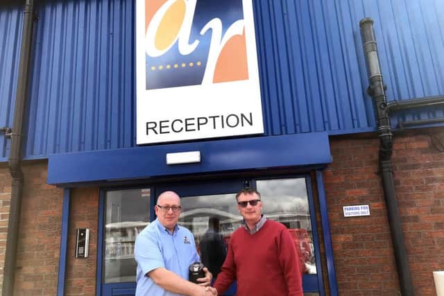 Paul Johnson (left) receives his long service award from Phil Ball, sales director at Alpha Rail