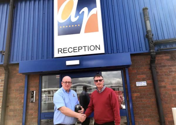 Paul Johnson (left) receives his long service award from Phil Ball, sales director at Alpha Rail