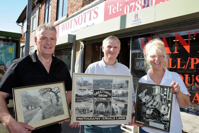 Coun. Lee Anderson, left, hands over a couple of prints to shop owners, Dale Burton from DMB Computers and Lynn Howell from Wot Notts on Sutton Road, Huthwaite, after getting hold of a number of historic photographs by photographer Ernald Lakin.