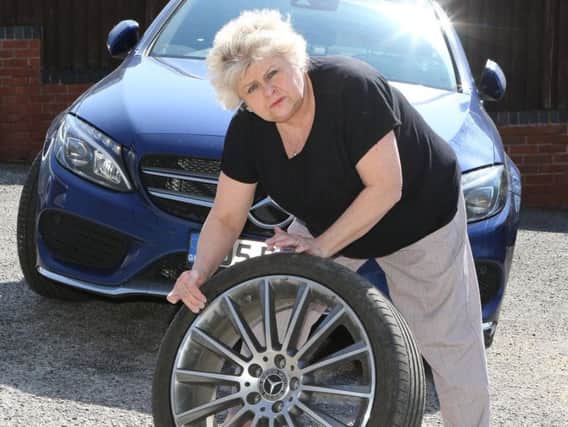 Carol Rogers with her wrecked tyre.