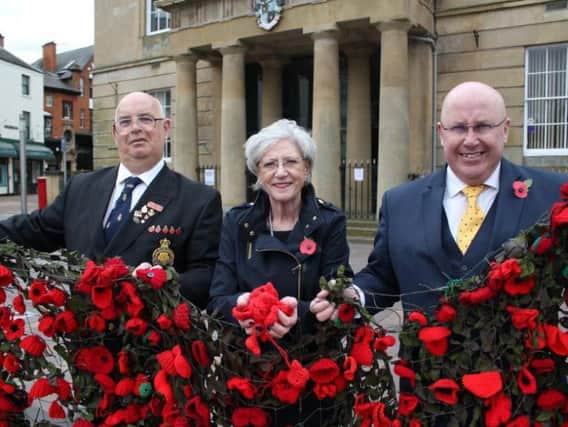 Michael Beresford of the Mansfield branch of the Royal British Legion, Executive Mayor Kate Allsop and deputy mayor Mick Barton with part of last year's netting and some recently donated poppies
