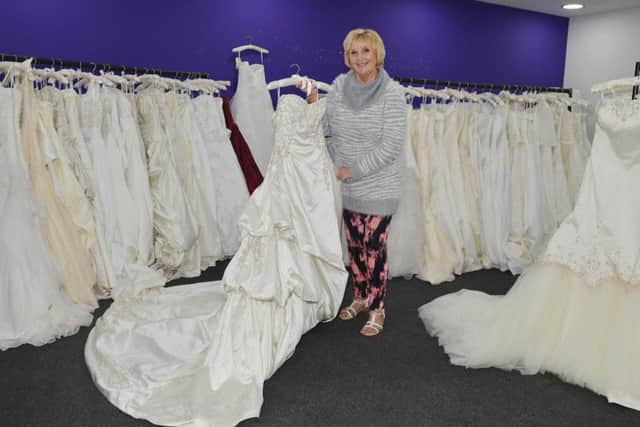 There are a hundred wedding dresses for sale.