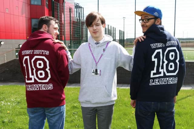 Cameron Moore shows off two of the hoodies with Jordan Pashley (left) and Milo Tooley-Okonkwo (right)