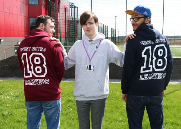 Cameron Moore shows off two of the hoodies with Jordan Pashley (left) and Milo Tooley-Okonkwo (right)