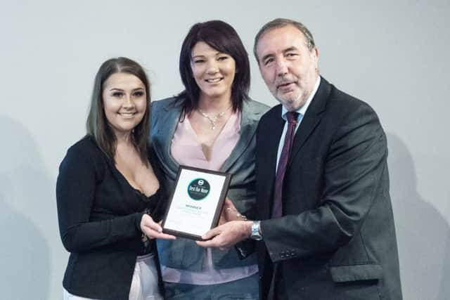 Manager Cerie McClure (centre) and assistant manager Megan Rose receive the award from police and crime commissioner Paddy Tipping.