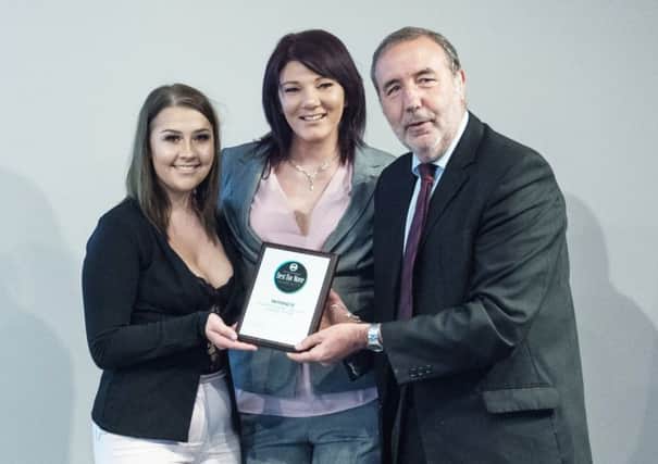 Manager Cerie McClure (centre) and assistant manager Megan Rose receive the award from police and crime commissioner Paddy Tipping.