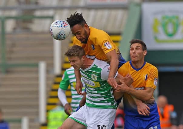 Picture by Gareth Williams/AHPIX.com; Football; Sky Bet League Two; Yeovil Town v Mansfield Town; 28/4/18  KO 15:00; Huish Park; copyright picture; Howard Roe/AHPIX.com; Stags' Rhys Bennett leaps above Yeovil's Alex Fisher