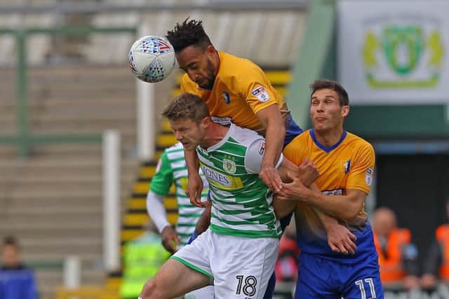 Picture by Gareth Williams/AHPIX.com; Football; Sky Bet League Two; Yeovil Town v Mansfield Town; 28/4/18 KO 15:00; Huish Park; copyright picture; Howard Roe/AHPIX.com; Stags' Rhys Bennett leaps above Yeovil's Alex Fisher