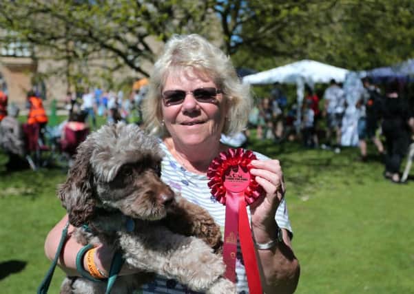 Susan Gregory holds Ripple and the rosette Ripple won for winning the waggiest tail competition.