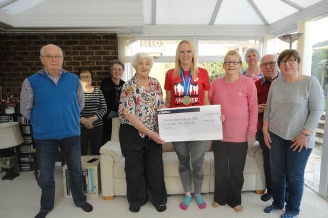 Rachel Street presents her cheque to the Amazons at Kings Mill Hospital