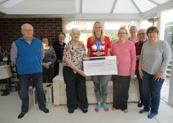 Rachel Street presents her cheque to the Amazons at Kings Mill Hospital