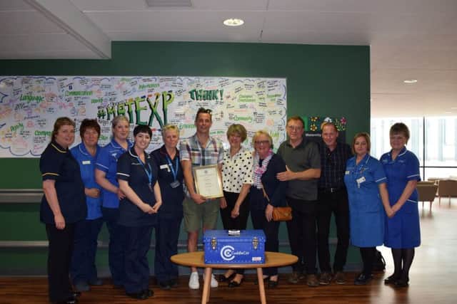Craig Renton  (centre) donating the cuddle cot with his and Heidis family and the teams that cared for both Heidi and Isabella.