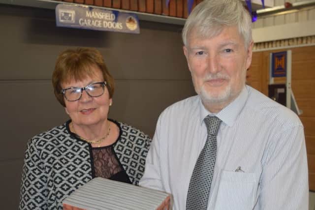 Graham and Sue Kirk with the company's 50th anniversary cake in the shape of a garage.