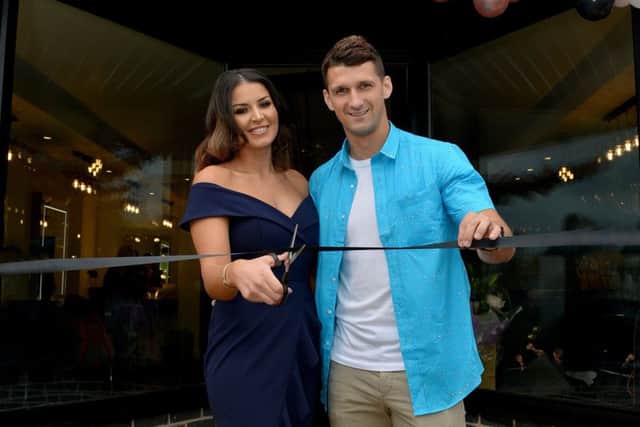 Official opening of K K Hair and Beauty, pictured is Kat Lichaj cutting the ribbon with Husband Eric Lichaj