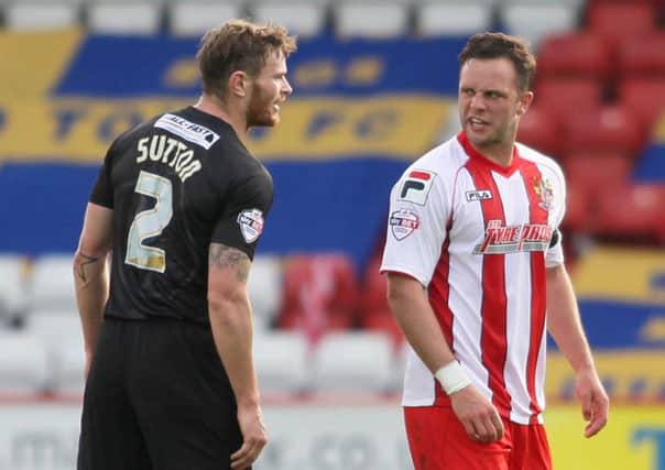 Ritchie Sutton exchanges views with Stevenage's Chris Beardsley -Pic by: Richard Parkes