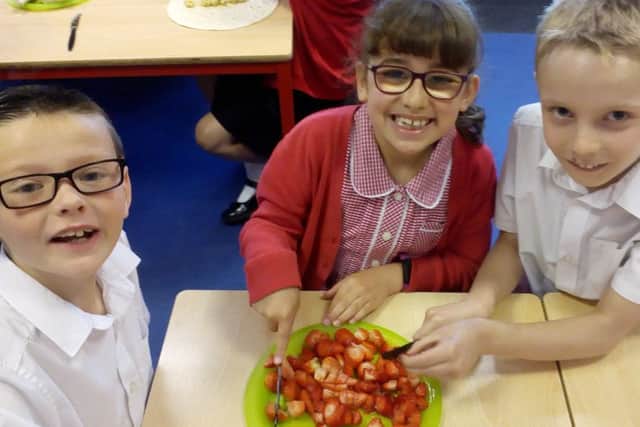 Three of the youngsters at Berry Hill Primary School preparing a tasty vegetarian treat.