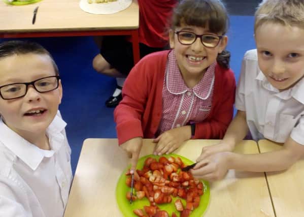 Three of the youngsters at Berry Hill Primary School preparing a tasty vegetarian treat.