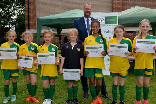 This Girl Does 6 aside girls only football tournament at Blidworth Oaks Primary School, fourth place team Blidworth collect their certificates from Notts County owner Alan Hardy