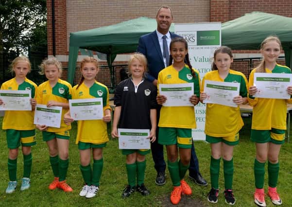 This Girl Does 6 aside girls only football tournament at Blidworth Oaks Primary School, fourth place team Blidworth collect their certificates from Notts County owner Alan Hardy