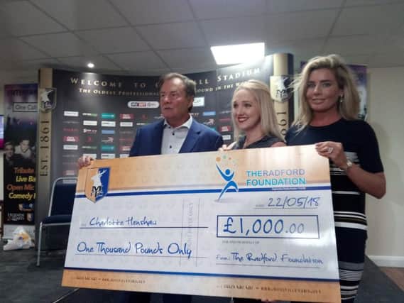 Charlotte Henshaw receives her cheque from the Radfords