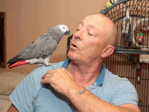Chris Phelan with his parrot.